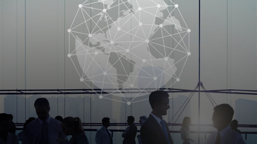 Global business professionals networking and shaking hands in a modern office setting, with a digital world map and global connection network overlay symbolizing international collaboration and digital transformation.