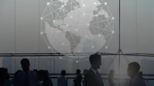 Global business professionals networking and shaking hands in a modern office setting, with a digital world map and global connection network overlay symbolizing international collaboration and digital transformation.